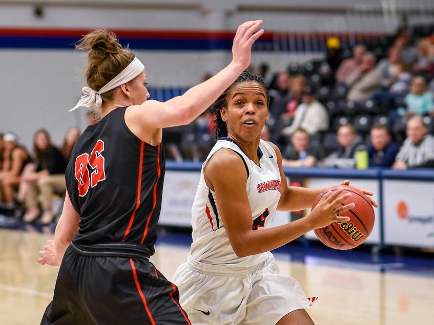 Two women playing basketball