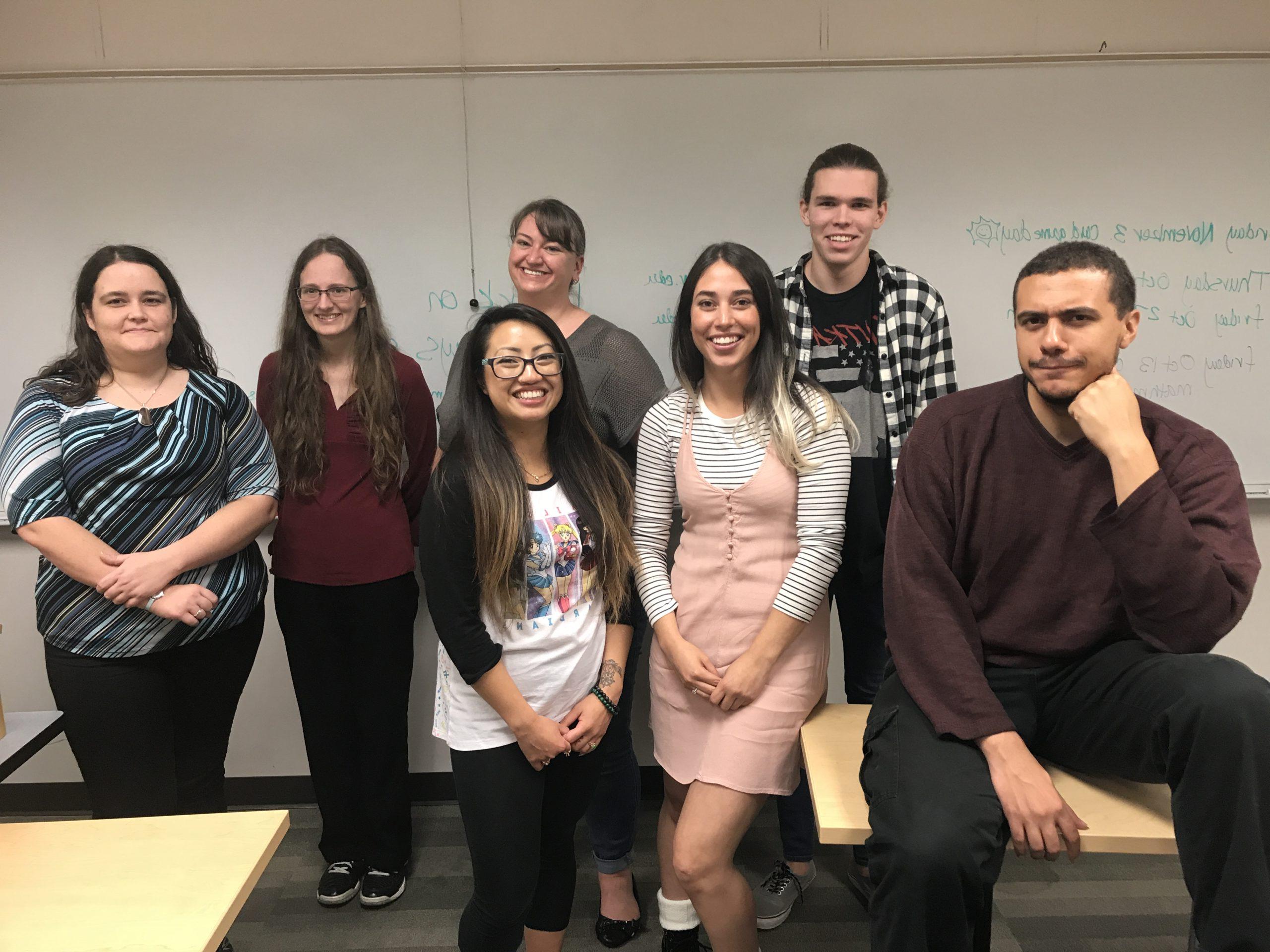 Students and professors posing for a picture in a classroom