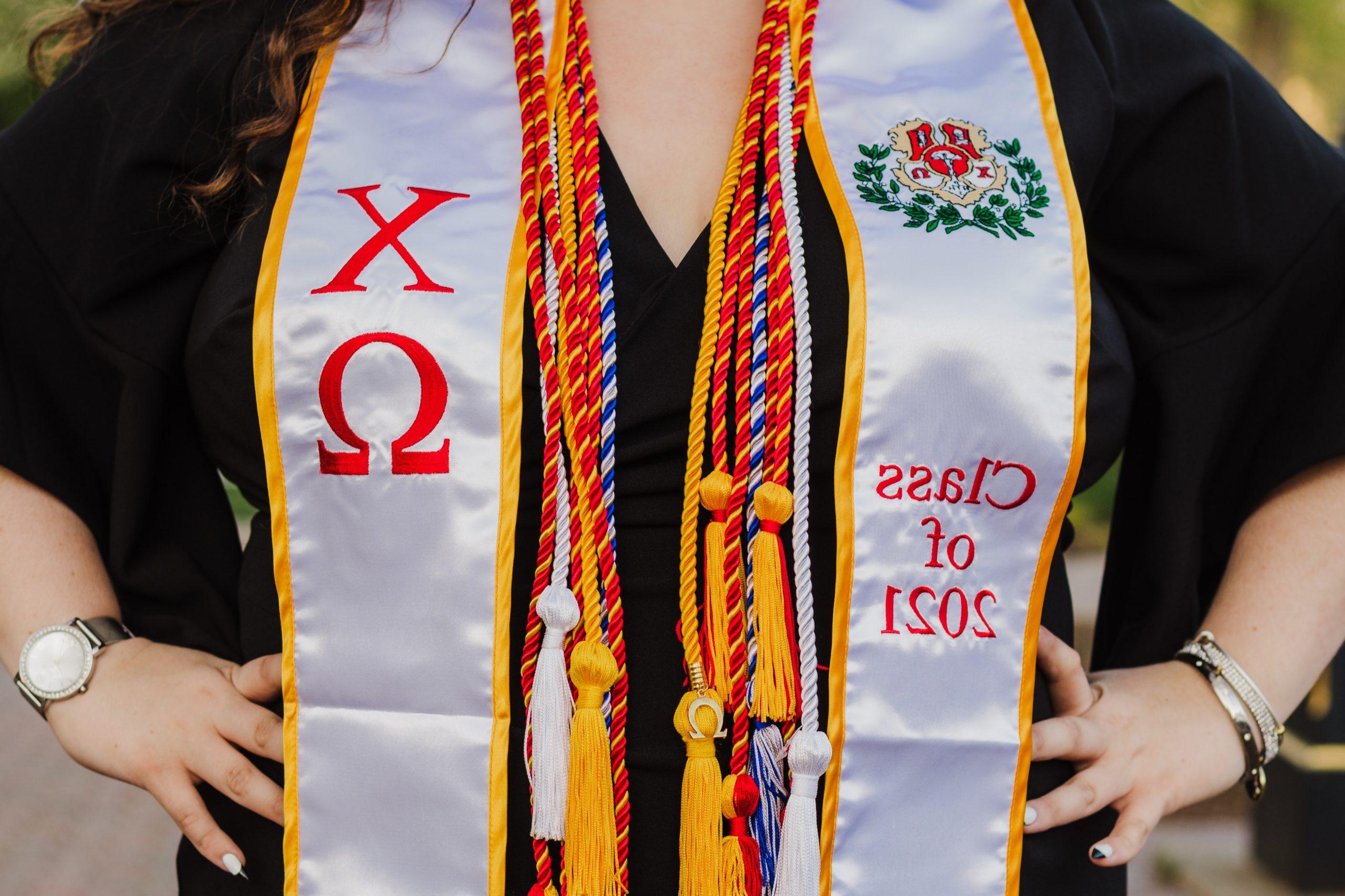 Graduation cords and stole hanging from a womans neck