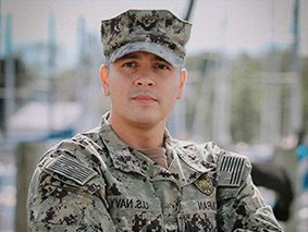 Leon Duran standing in his U.S. Navy uniform.